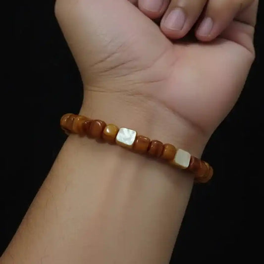 Close-up shot of a stretchable bracelet made with organic, polished amber beads.