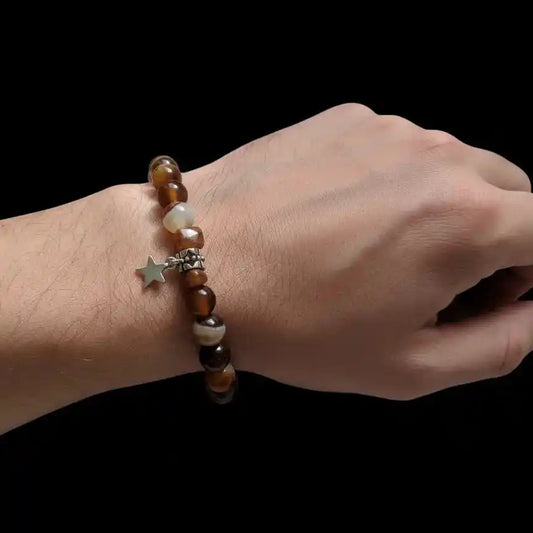 Elastic brown agate bead bracelet featuring a small, silver-tone star charm.