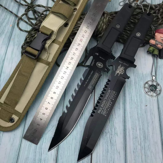 Black tactical knife with sheath and ruler on a wooden surface