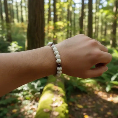 Close-up view of howlite beads with gray veining and polished brown accent beads.
