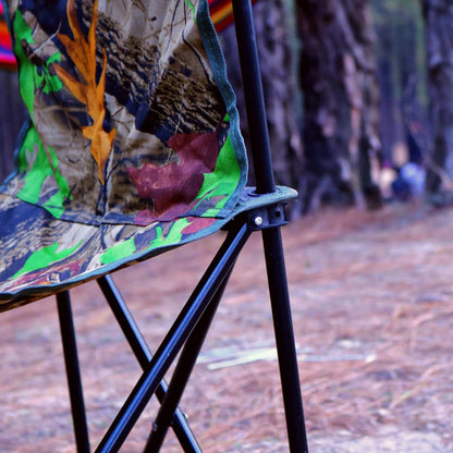 Colorful camouflage-patterned chair in a forest setting