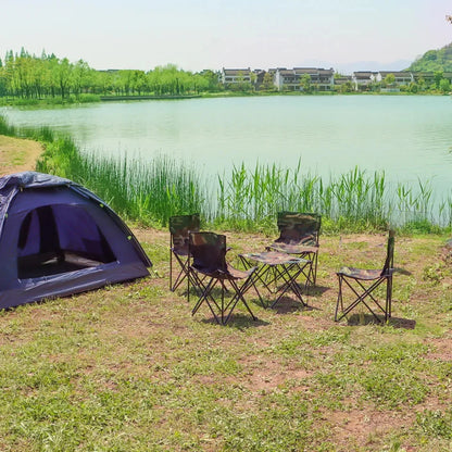 Camping setup with a tent and chairs by a lake