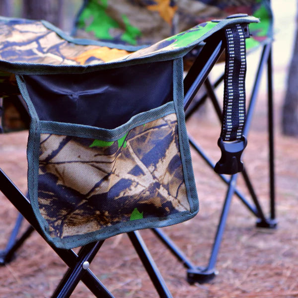 Camouflage-patterned bag attached to a chair with a blurred outdoor background