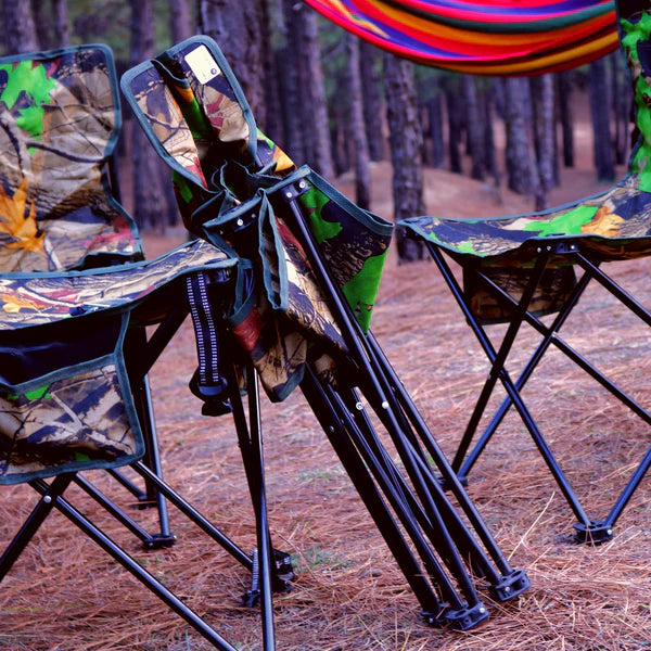 Camouflage camping chairs in a forest setting with a colorful hammock.
