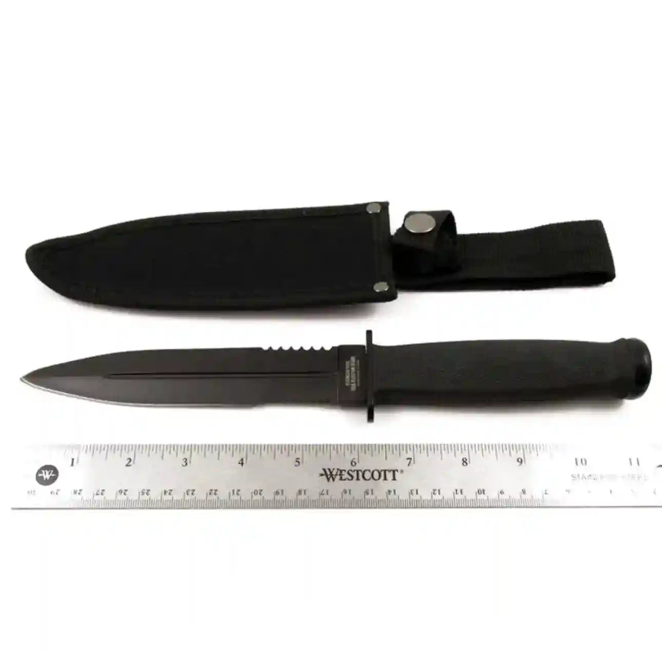 Black knife with sheath and ruler for scale on a white background