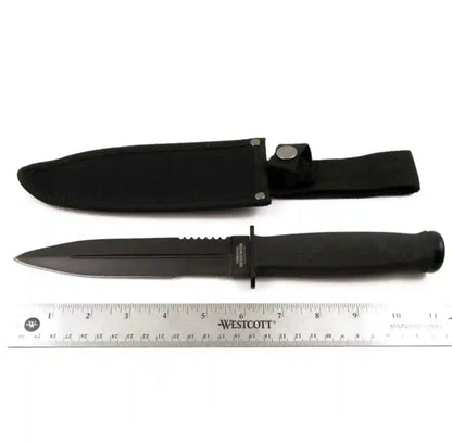 Black knife with sheath and ruler for scale on a white background