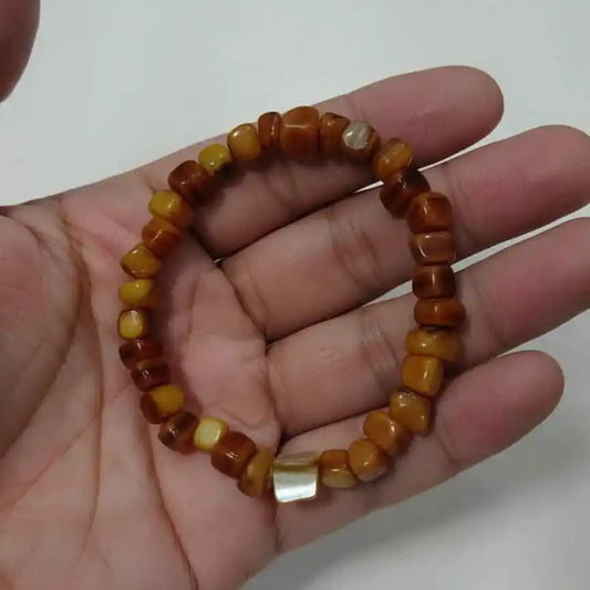 Natural amber nugget bead bracelet displaying various shades of yellow and brown.
