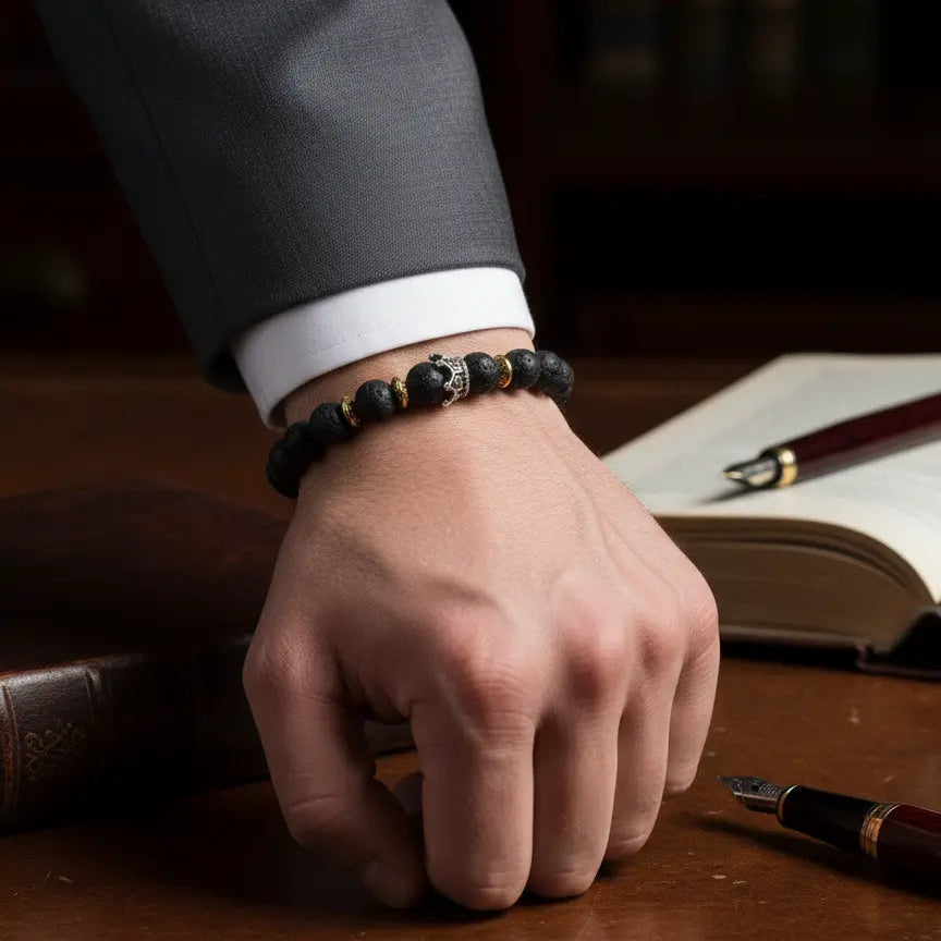"Close-up of a person's wrist wearing two stacked 'Beets' lava bead bracelets."